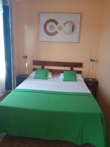a bedroom with a large green and white bed at Hibiscus chez Arielle in Rodrigues Island