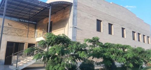 a building with a tree in front of it at RUBENYAN GUEST HOUSE in Artashat
