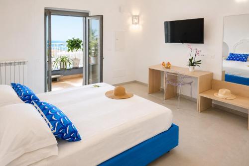 a bedroom with a large bed and a television at La Terrazza del Sole a Positano in Positano