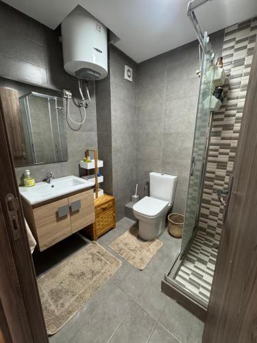 a bathroom with a toilet and a sink and a shower at Smir Park apartamento in Marina Smir