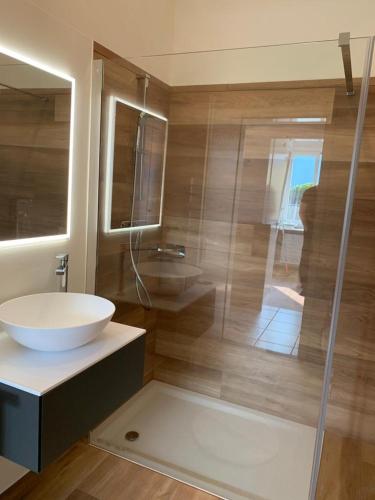 a bathroom with a sink and a glass shower at Wohnung nr 103 in Muralto