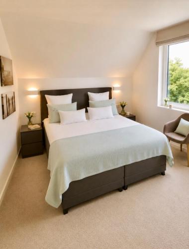 a large bedroom with a large bed with white pillows at VILLA FER-GUY " Beeldige Suite met parking, nabij strand en casino" in Knokke-Heist