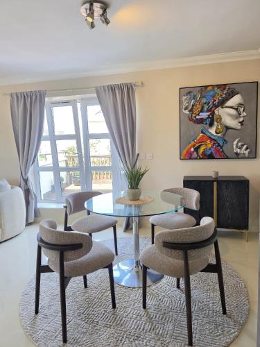 a living room with a table and chairs at 2 Bedr Portmarnock Dublin Suburb in Dublin