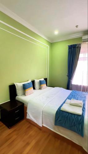 a bedroom with a large white bed and a window at Marvarid INN in Samarkand