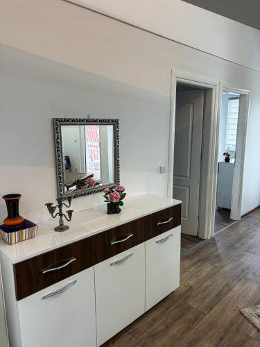 a bathroom with a sink and a mirror at Harmony Rooms & Apartments in Vogošća