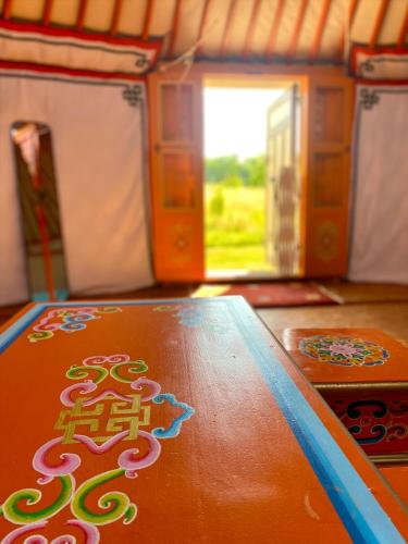 a wooden table with a chinese sign on it at La Dorépontaise YOURTE MONGOLE in Pondaurat