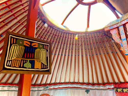 a picture of a painting on a ceiling in a room at La Dorépontaise YOURTE MONGOLE in Pondaurat