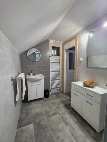 a bathroom with a white sink and a mirror at Kuća za odmor Lipa Dora near Plitvice in Donji Babin Potok