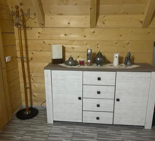 a white cabinet in a room with wooden walls at Wooden Fairytale in Bihać