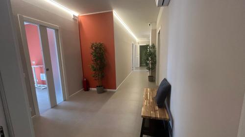 a hallway with a wooden bench in a room at Panda House - Padova Station in Padova