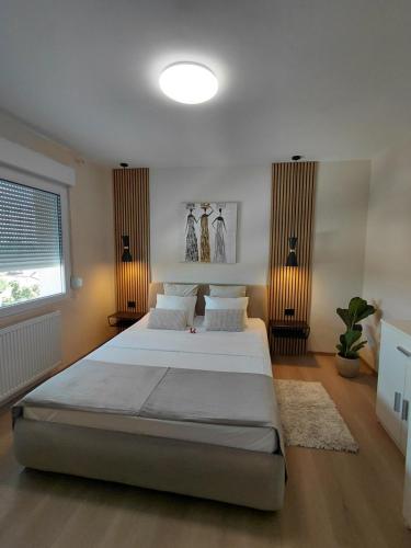 a large bedroom with two beds and a window at Apartman Sandra in Varaždin