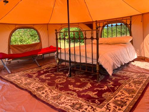 a bedroom with a bed in a tent at Sunset view in Hereford