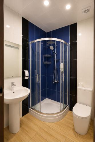 a bathroom with a shower and a toilet and a sink at Sahil Bay Hostel in Baku