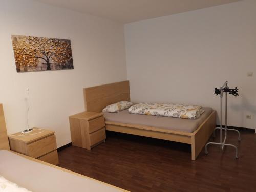a bedroom with a bed and a painting on the wall at Monteurwohnung Hoffmann in Heilbronn