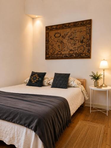 a bedroom with a bed with a map on the wall at Casa de Sta Clara in Évora