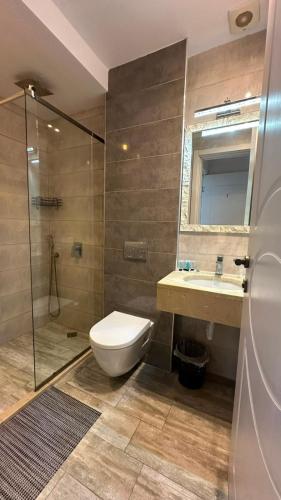 a bathroom with a toilet and a glass shower at National Lux in Ureki