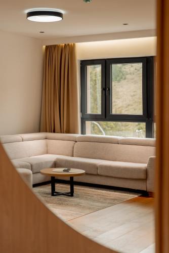 a living room with a couch and a coffee table at Horizont Aparthotel Jahorina in Jahorina