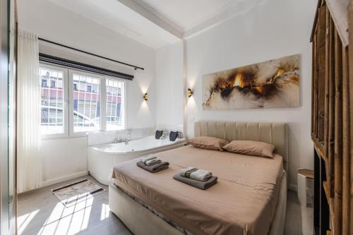 a bedroom with a bed and a bath tub and a sink at Green Luxe Suite 1 by PikHost in Shkodër