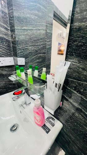 a bathroom with a sink with glasses and a mirror at Victory Villa Sigiriya in Sigiriya