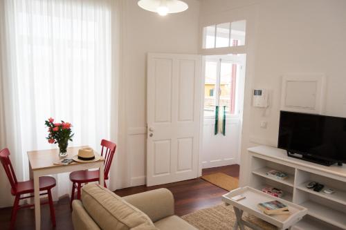 a living room with a couch and a table at Casa Do Mercado by Heart of Funchal in Funchal