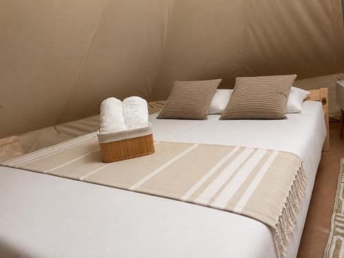 two beds in a tent with towels on them at Bulamac Luxury Glamping in Vama Veche