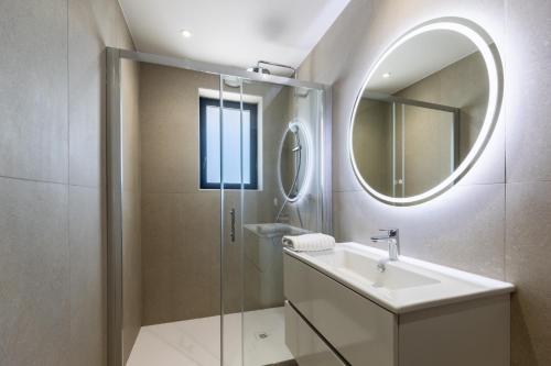 a bathroom with a sink and a mirror at Appart'hotel Saint Francois in Calvi
