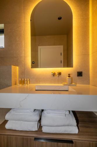 a bathroom with a sink and a mirror at North Mountain View Suites in Akureyri