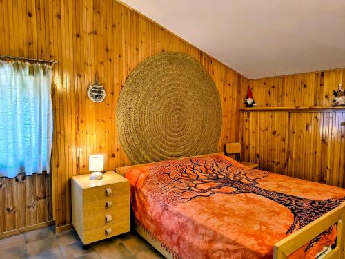 a bedroom with a bed with a tree design on it at repaci 17 home in Camigliatello Silano