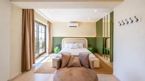 a bedroom with a bed and a couch at Luz Suites in Kaş