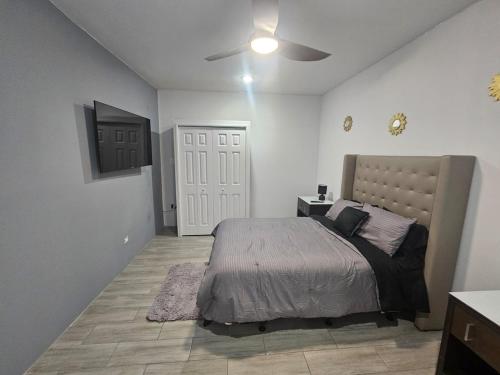 a bedroom with a bed and a ceiling fan at z'view apartments in Cayon