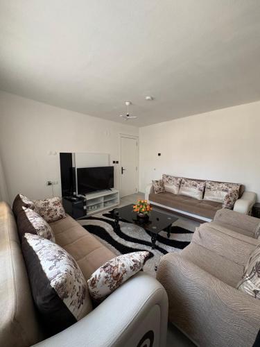 a living room with two couches and a flat screen tv at HAPPY HOUSE 2 Pamukkale in Pamukkale