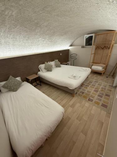 a room with two beds in a room at Le Col Getaway Virage 1 in Le Bourg-dʼOisans