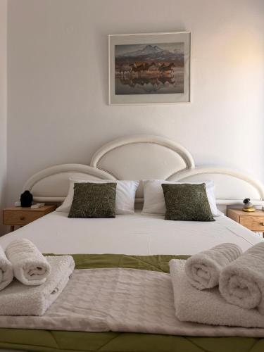 a bedroom with two beds with towels on them at KROKOS HOUSE in Aliveri