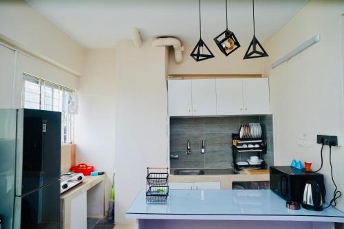 a kitchen with a blue counter top in a room at Hola Properties in Dhaka