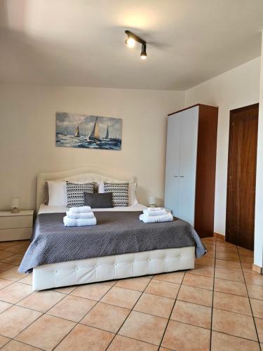 a bedroom with a large bed in a room at Casa Giulia Olbiamare in Olbia