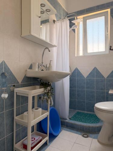a bathroom with a sink and a toilet at KROKOS HOUSE in Aliveri