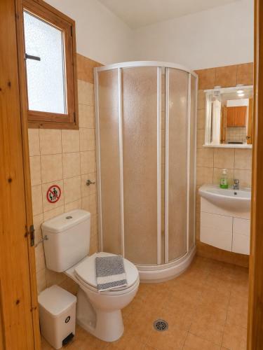 a bathroom with a shower and a toilet and a sink at Marialena hotel in Archangelos