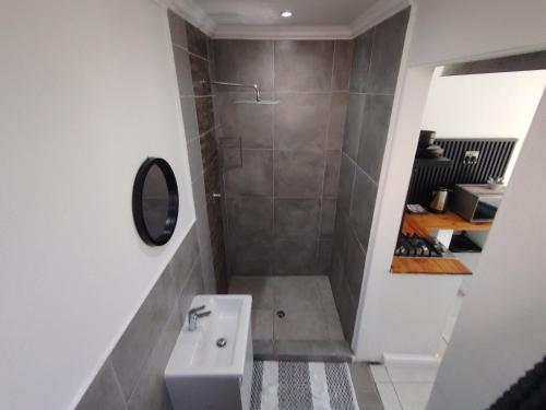 a small bathroom with a sink and a shower at 284 on circular 3 in Sunridge Park