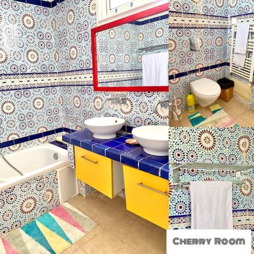 a bathroom with two sinks and a mirror and a tub at Villa Omi Zina in Nabeul