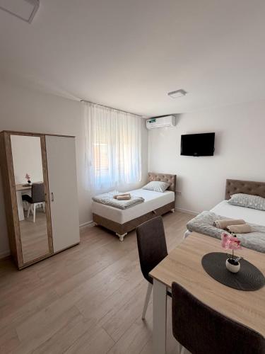 a living room with a bed and a couch and a table at Vila Šarić in Doglodi
