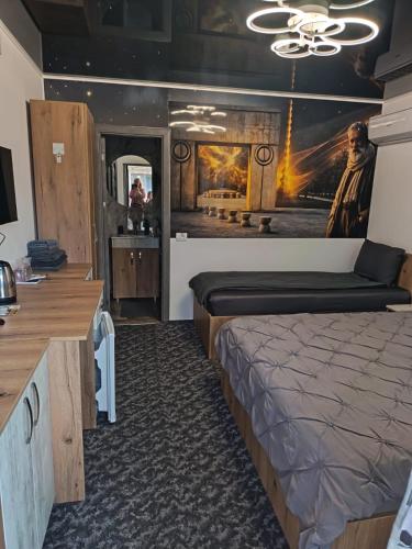 a bedroom with a bed and a painting on the wall at Sofia Armony in Iezureni