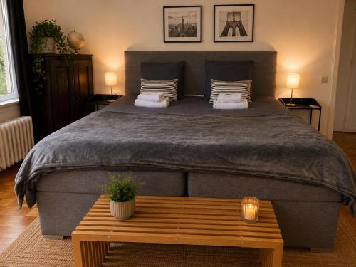 a bedroom with a large bed with a wooden table at Secret Garden in Waterloo