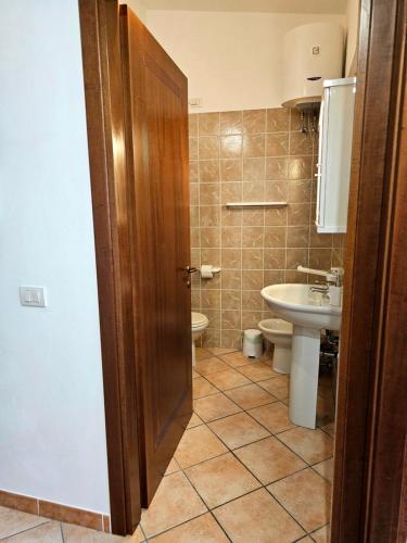 a bathroom with a toilet and a sink at Casa Giulia Olbiamare in Olbia