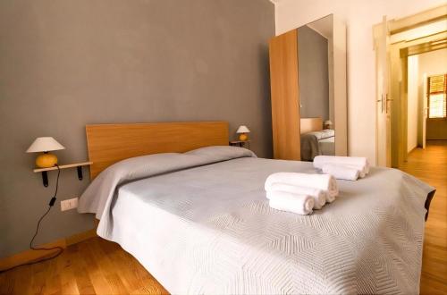 a bedroom with a large bed with towels on it at CASA ARUCI in Avola