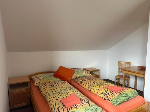 a bed in a small room with two beds at Chalet Parížovce with swimming pool and mountain views in Liptovský Trnovec