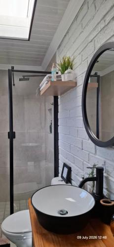 a bathroom with a white sink and a mirror at Studio 149 - Wild Coast Accommodation in Sunrise-on-Sea