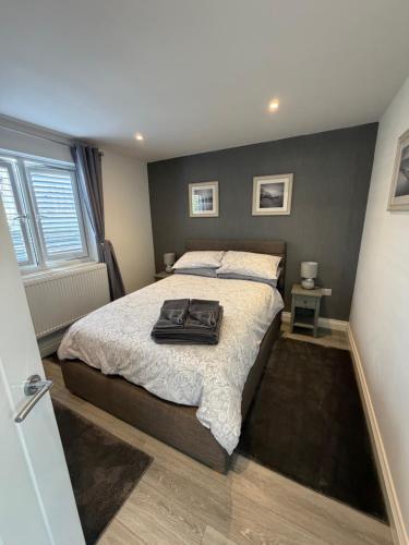 a bedroom with a bed with a suitcase on it at Home Away From Home in Blean