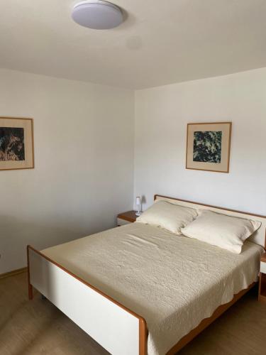 a bedroom with a bed in a white room at Campanella Old Town by Mrav in Sukošan