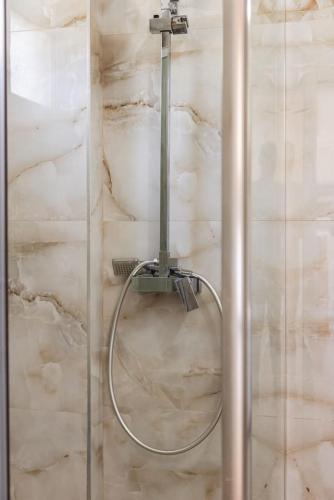 a shower with a hose in a bathroom at Siar The Large Villa by PikHost in Borsh
