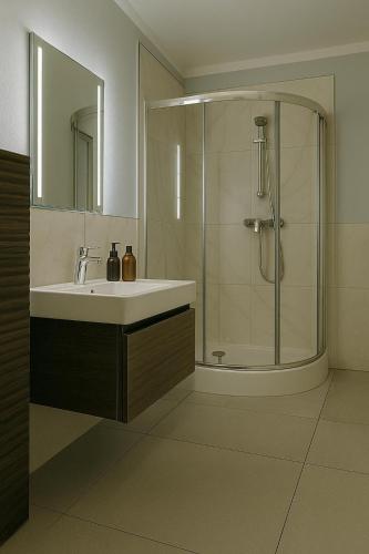 a bathroom with a sink and a shower at Apartament Fabryczna Premium TK in Namysłów